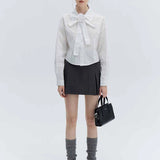 Chic Black Tie-Front Cropped Blouse with Elegant Rose Knot