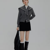 Contemporary Knit Cardigan with Contrast Piping and Tie-Neck Detail