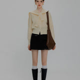 Contemporary Knit Cardigan with Contrast Piping and Tie-Neck Detail