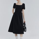 Elegant Short-Sleeve Dress with Decorative Neckline and Bow Detail