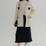 Ivory Wool Coat with Black Bow Details and Contrast Trim - Elegant Winter Wear